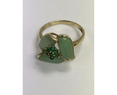 A 9 ct gold ring inset with green stone of floral design size Q .