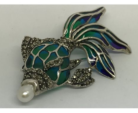 A silver fish brooch/pendant set with a pearl in its mouth and marcasites and inlaid with coloured enamel