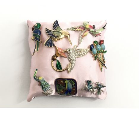 A collection of eight enamel brooches decorated with various birds