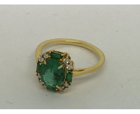 A yellow gold emerald and diamond ring, emerald 1.70ct approx. Diamonds 0.13ct approx. Ring size L