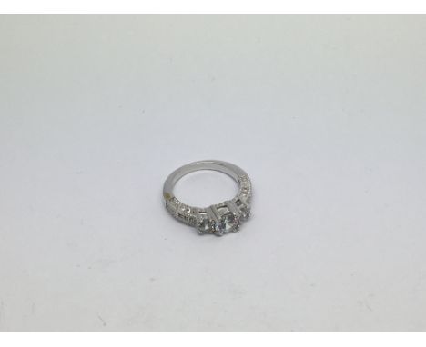 A 10ct white gold ring set with 3 moissanite stones. Size n approx weight 3.5g