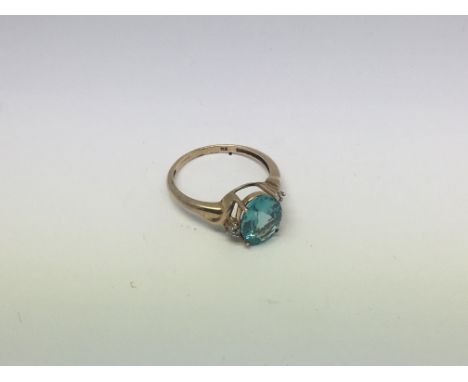 A 9ct gold ring set with 1 topaz and 2 diamonds. Size o approx weight 2.4g