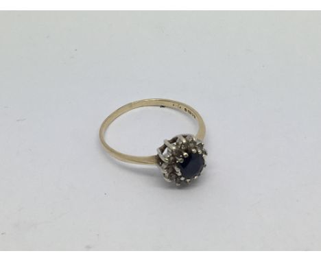 A 9ct gold ring set with a sapphire and diamond cluster. Size q/r approx weight 1.7g