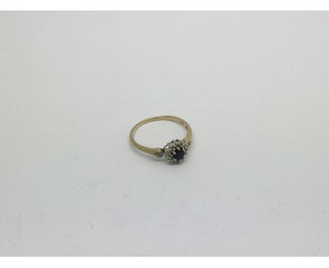 A 9ct gold ring set with a sapphire and diamond cluster. Size r/S approx weight 2g