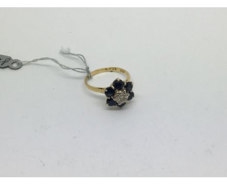 An 18ct gold ring set with 6 sapphires and diamond. Size k/l approx weight 3.9g