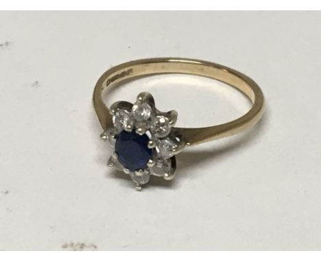 A 9carat gold ring set with a sapphire and small brilliant cut diamonds ring size N-O