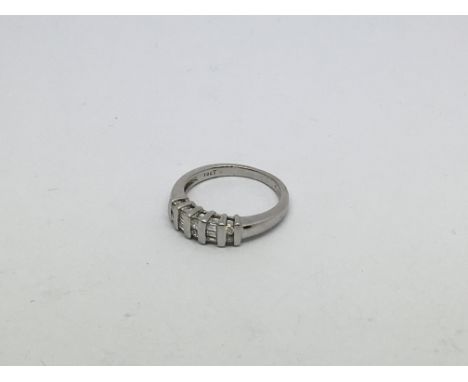 An 18ct white gold ring set with emerald cut and brilliant cut diamonds approx 0.25ct. Size k/l approx weight 3.9g