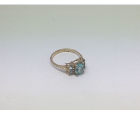 A 9ct gold ring set with topaz and aqua marine 5 stones. Size n approx weight 2.6g