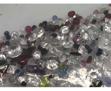 A bag of loose mixed stones including cubic zirconia, emerald, blue topaz, sapphire, ruby and amethyst 79.43ct