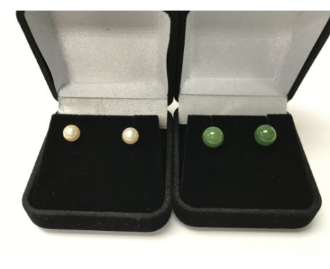 A pair of 9ct gold and jade studs plus a pair of 9ct gold pearl studs.