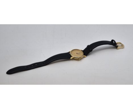 A Raymond Weil 9ct. gold ladies' quartz wrist watch, having signed circular champagne dial with applied gold dot indices, gol