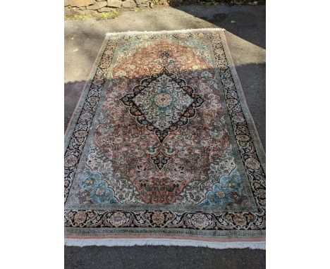 A machine woven Persian Kashmiri style rug, central medallion gul, and all over floral decoration, triple guard boarder and t