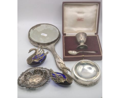 A group of silver items to include a two piece christening egg cup and spoon, a pin dish with pierced design, a pair of white