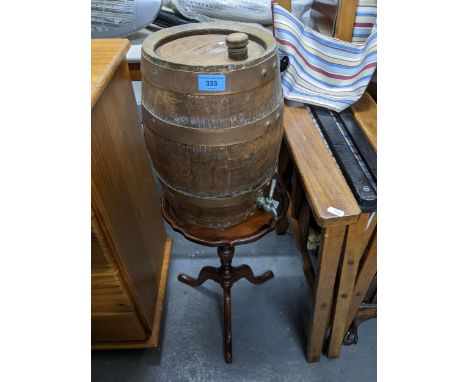 Victorian carved oak and brass fire bellows, a reproduction mahogany pedestal wine table, and a small wooden wine barrel with