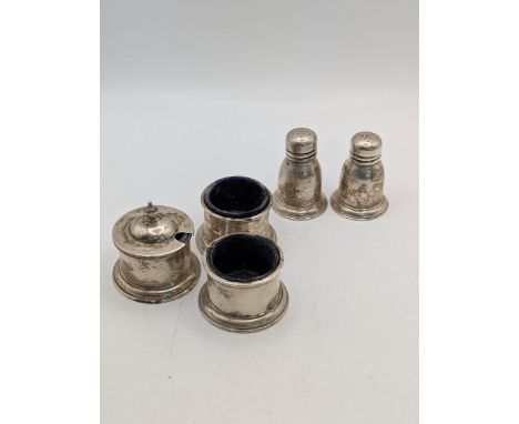 Birks sterling silver condiments to include two pepper pots, two salts, and a mustard pot with lid A/F, total weight excludin