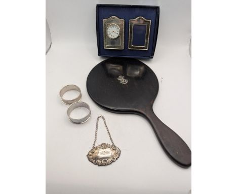 A mixed lot to include a silver decanter label Brandy, a pair of engine turned napkin rings, along with a silver front Kitney