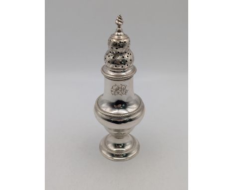 A George III silver sugar coasters on a circular base with a gadrooned borders and flame finial Location:If there is no condi