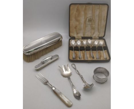Silver items to include a fruit serving spoon with twisted handle design by Amanda Birkett along with a set of six tea spoons