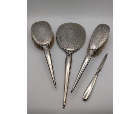 A Birks sterling silver four-piece dressing table set having floral engraved decoration and the initial 'L' engraved into eac