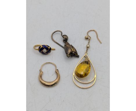 A group of single earrings to include a yellow metal blue enamel and pearl earring testes as 18ct 1.1g together with a 9ct go