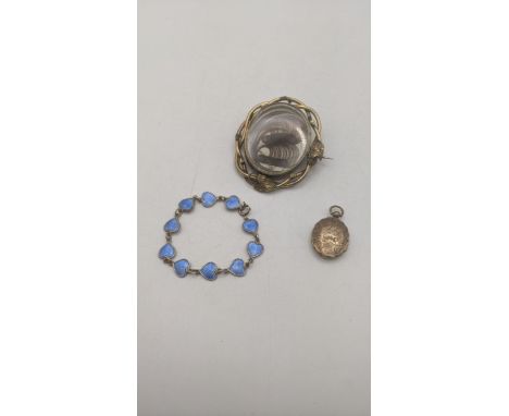 A group of jewellery to include a Victorian revolving hair mourning brooch mounted in a gold plated frame, together with a go