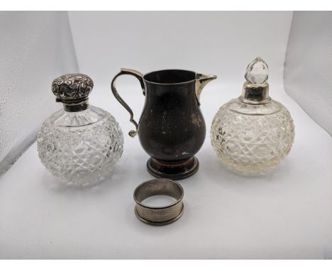 Two crystal glass scent bottles, one with a silver collar and lid hallmarked Birmingham 1927 and one other with a silver coll