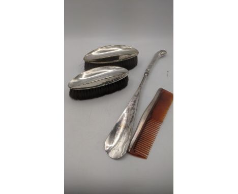 A group of silver dressing table items to include a silver handled shoe horn, a comb and two silver backed brushesLocation:If
