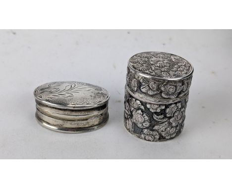 Two small silver trinket boxes to include an oval example, possibly for snuff, engraved with a floral design, 21.5g Location: