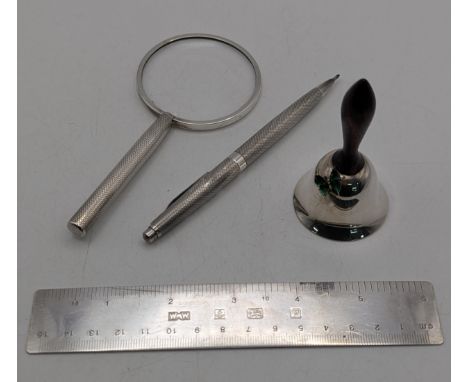 A group of silver collectables t include a ruler 41g, hallmarked Birmingham 1995 along with a small bell, magnifying glass, a