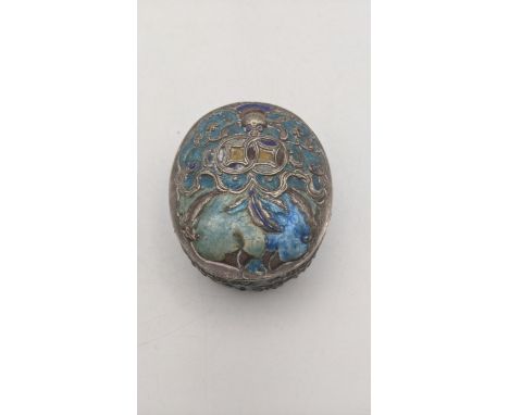 A late 19th/early 20th century continental white metal and enamel snuff box of oval form with repousse white metal floral dec
