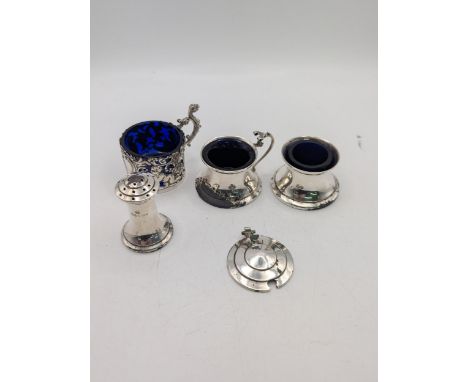 Four silver condiments to include a pepper pot, salts and two mustard pots A/F, total weight excluding blue glass liners 90.4