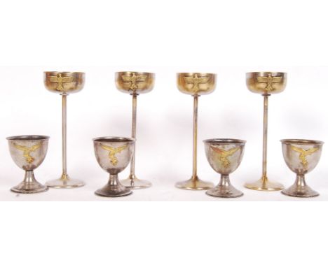 A set of 4x 20th century WWII Second World War Nazi Third Reich German egg cups. Each with brass swastika and eagle motif to 