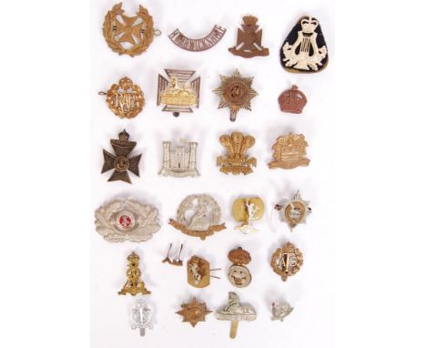 A collection of 25x First/ Second World War military cap badges to include; RAF, R. Warwickshire, Blackpool Volunteers, The N