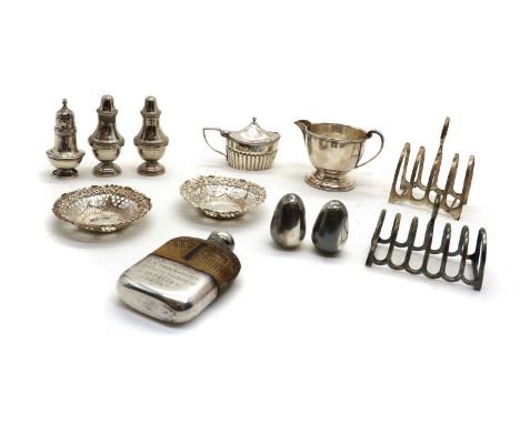 A collection of silver items,comprising a Victorian mustard pot, London 1888, with a hinged cover, a blue glass liner and par