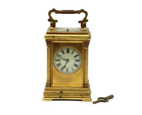 A French brass cased repeating carriage clock,the circular enamel dial with Roman numerals, the case with Corinthian quarter 