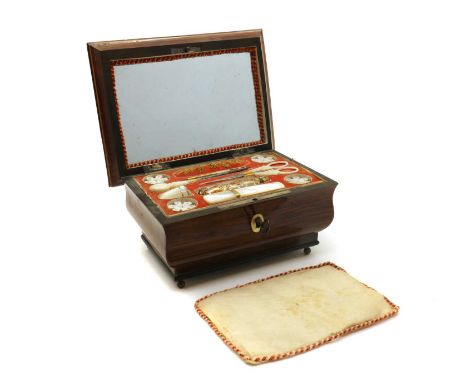An early Victorian rosewood work box,of sarcophagus shape, the interior with a mirror to the hinged lid and a lift-out tray w