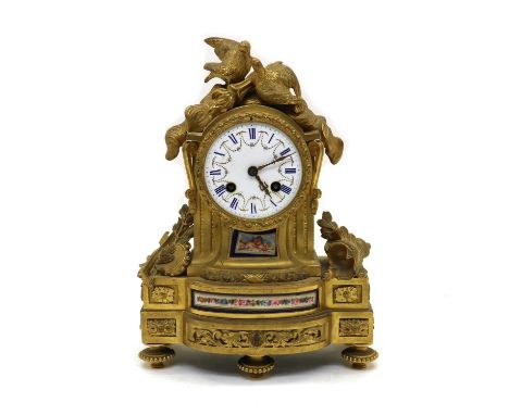 A French gilt-cased mantel clock,c,1870, with a white enamel dial and striking on a bell, the case with porcelain inset panel