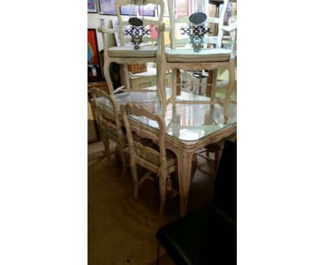 French, extendable dining table, hand painted in off white. Foliage detail to legs and underside. Glass top.. Item measures a