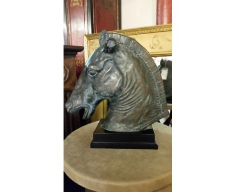 Substantial sculpture of a horses head on wooden base. Item measures approx: 40cm wide, 44cm high