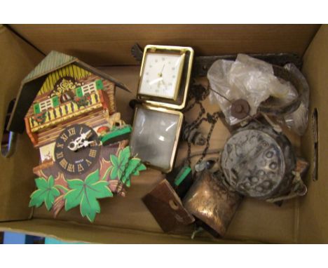A mixed collection of items to include: small cuckoo clock, wind chimes, travel clock. 