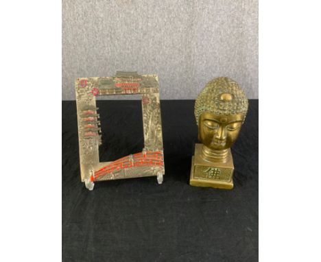 A vintage brass Buddha's bust along with a Japanese embossed metal picture frame. H.19cm x W.6.5m x D.6.5cm 
