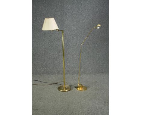 A brass standard lamp with articulated arm along with a floor standing spot lamp. H.140cm. (largest). 