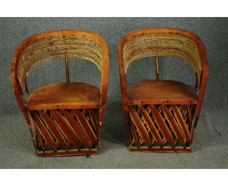 A pair of vintage cane and bamboo tub armchairs with leather seats. H.80cm. (each). 