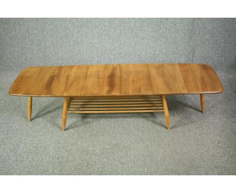 A mid century Ercol coffee table, model 456 in elm and beech. H.36 W.158 (ext) D.46cm. 