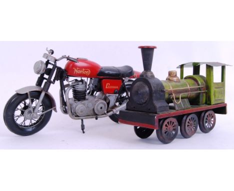 Two vintage style, Tinplate models. One of a red Norton Motorcycle and the other a green steam train. Norton measures 33cm an