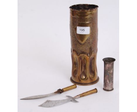 A collection of trench art (and related) pieces - mostly WWI, to include; a large fluted decorated shell, letter openers and 