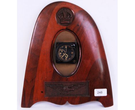 An original aircraft Smiths MK 5B cockpit clock within a wooden carved wing tip with an eagle and crown motif. Approx 30cm ta