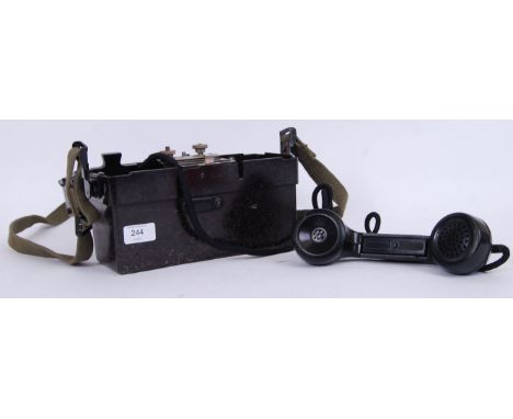 A Second World War WWII or later German Field telephone. Appears to be complete and comes with canvas strap.  POSTAGE: Worldw