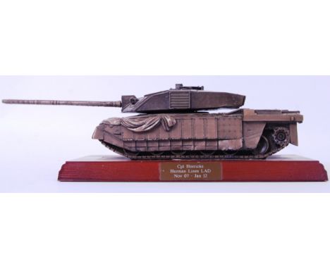 An unusual resin model tank awarded to a Cpl Horricks,  Harman lines LAD. Mounted on a wooden base. 11cm tall.  POSTAGE: Worl