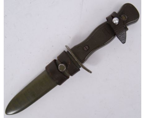 An unusual US Army style combat dagger in original green metal scabbard and with leather frog. The blade marked for Solingen.